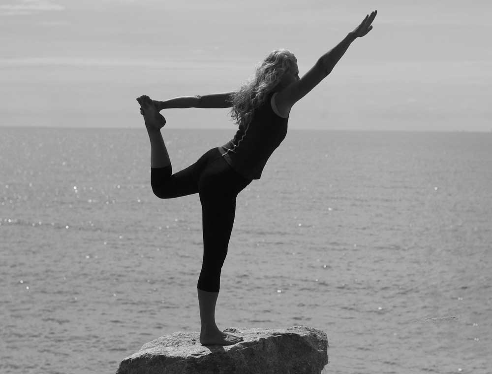 dancer pose yoga at the beach