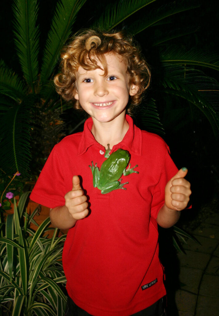 green frog on small boy